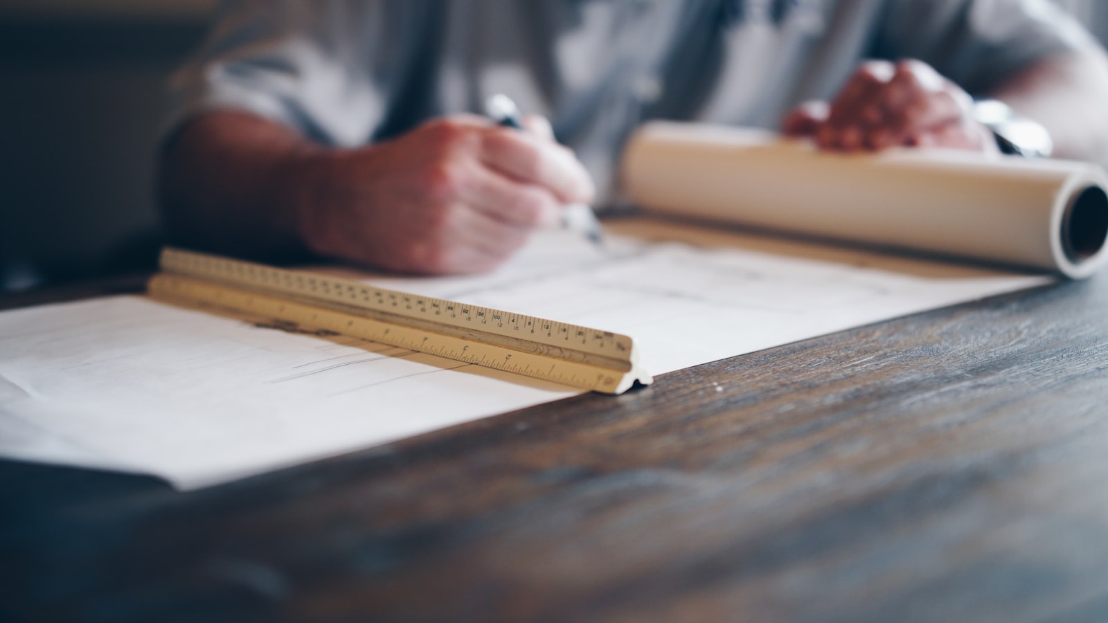 Engineer drafting on a blueprint &mdash; safety considered at the design stage